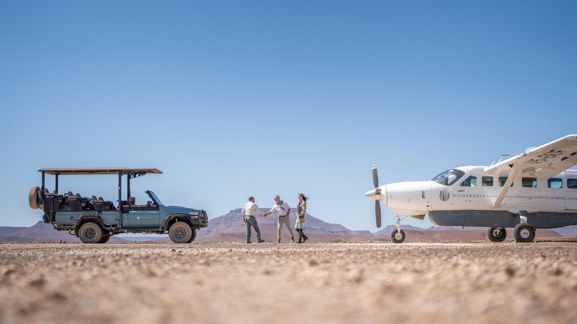 an image of guests and an airplane at wonders of desert rhino in namibia
